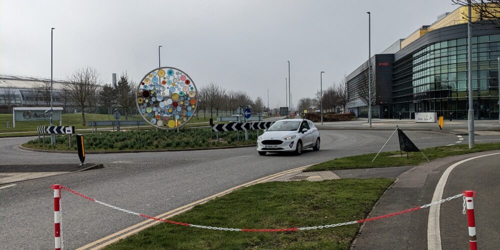 a picture of a Net CS car driving around a roundabaout at the Harwell campus for the continuous wave testing.