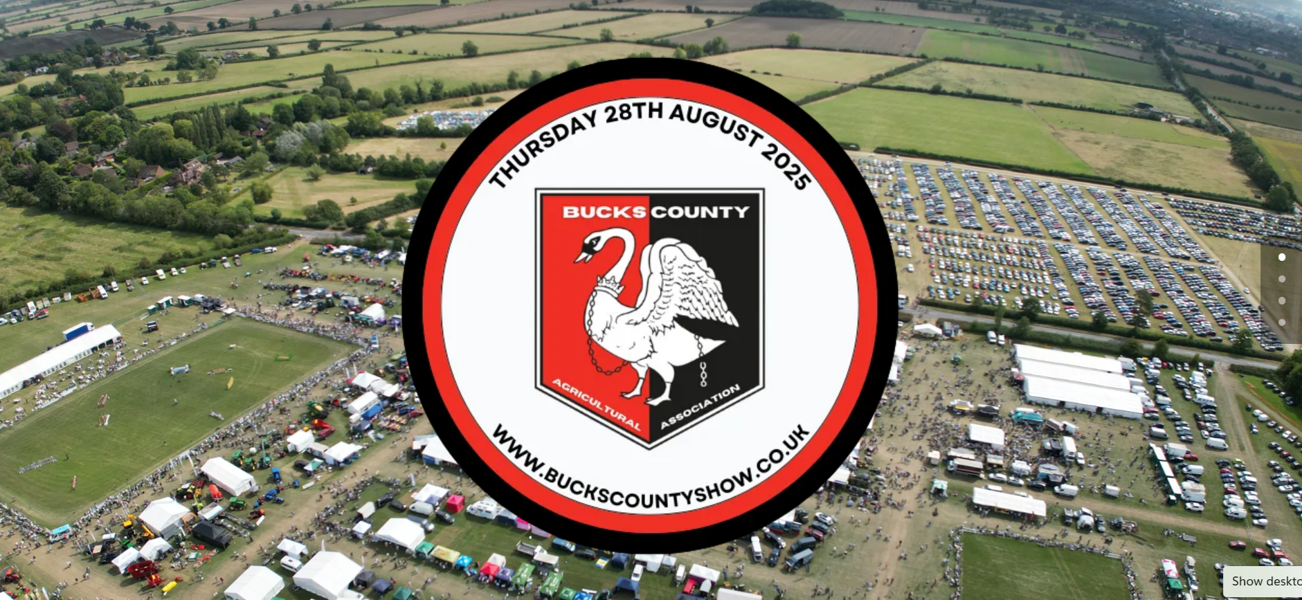 image shows red and black circular Bucks County Show logo overlaying an aerial view of a previous year's county show